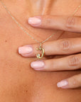Initial U Gold necklace with a pendant on a person's neck