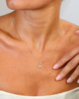 Gold necklace with on a person's neck