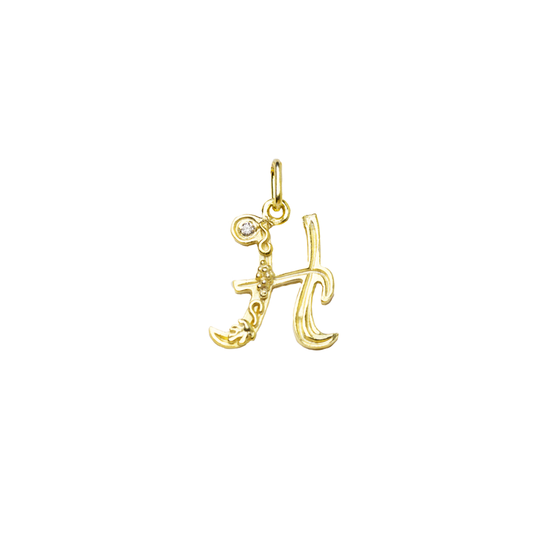 Gold letter 'H' pendant on a white background
