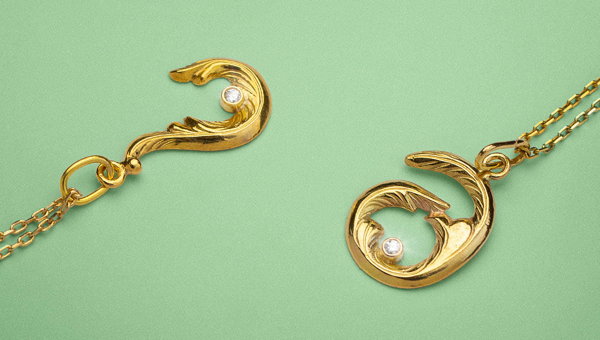 Gold pendant and necklace set on a green background