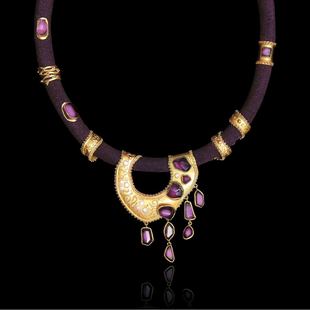 Ornate necklace with purple gemstones on a black background