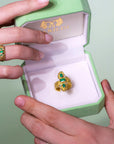 Marilisi Gold and Emerald ring damasco in gift box held by womand and a man