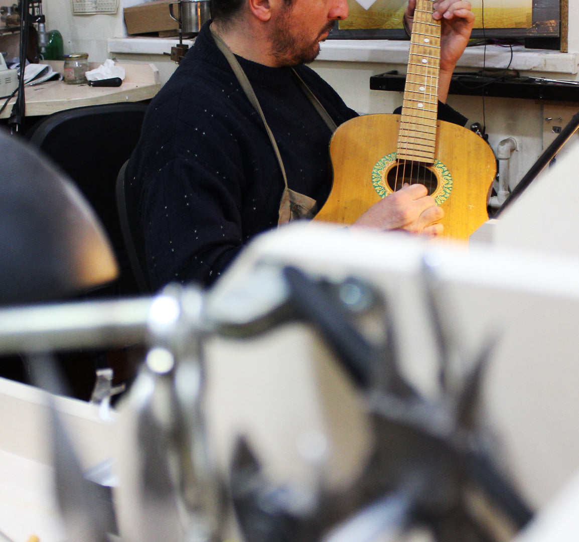 Marilisi Jewelry House artisan playing guitar in the workshop, reflecting the artistic spirit and craftsmanship behind each jewelry piece.