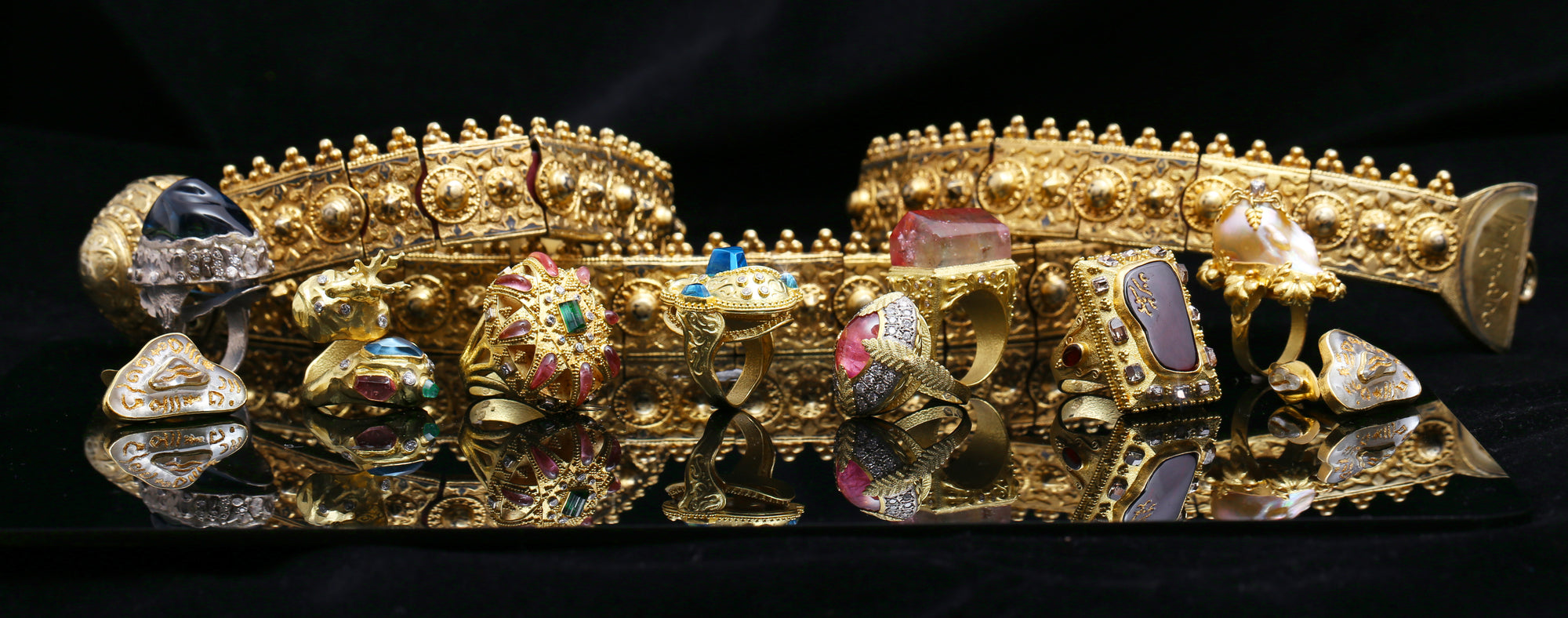 Collection of high jewelry by Marilisi close up of rings and gold belt