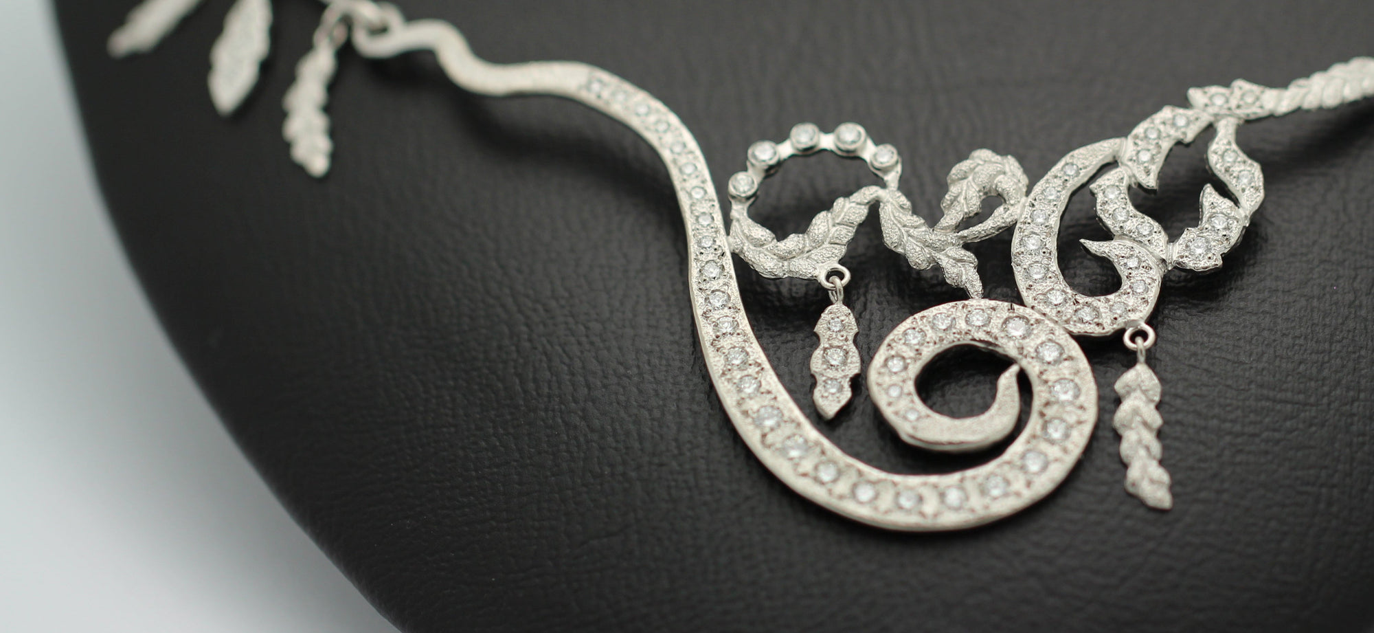 Close up of black leather bust with high jewelry necklace in white gold and diamonds from Marilisi Jewelry House