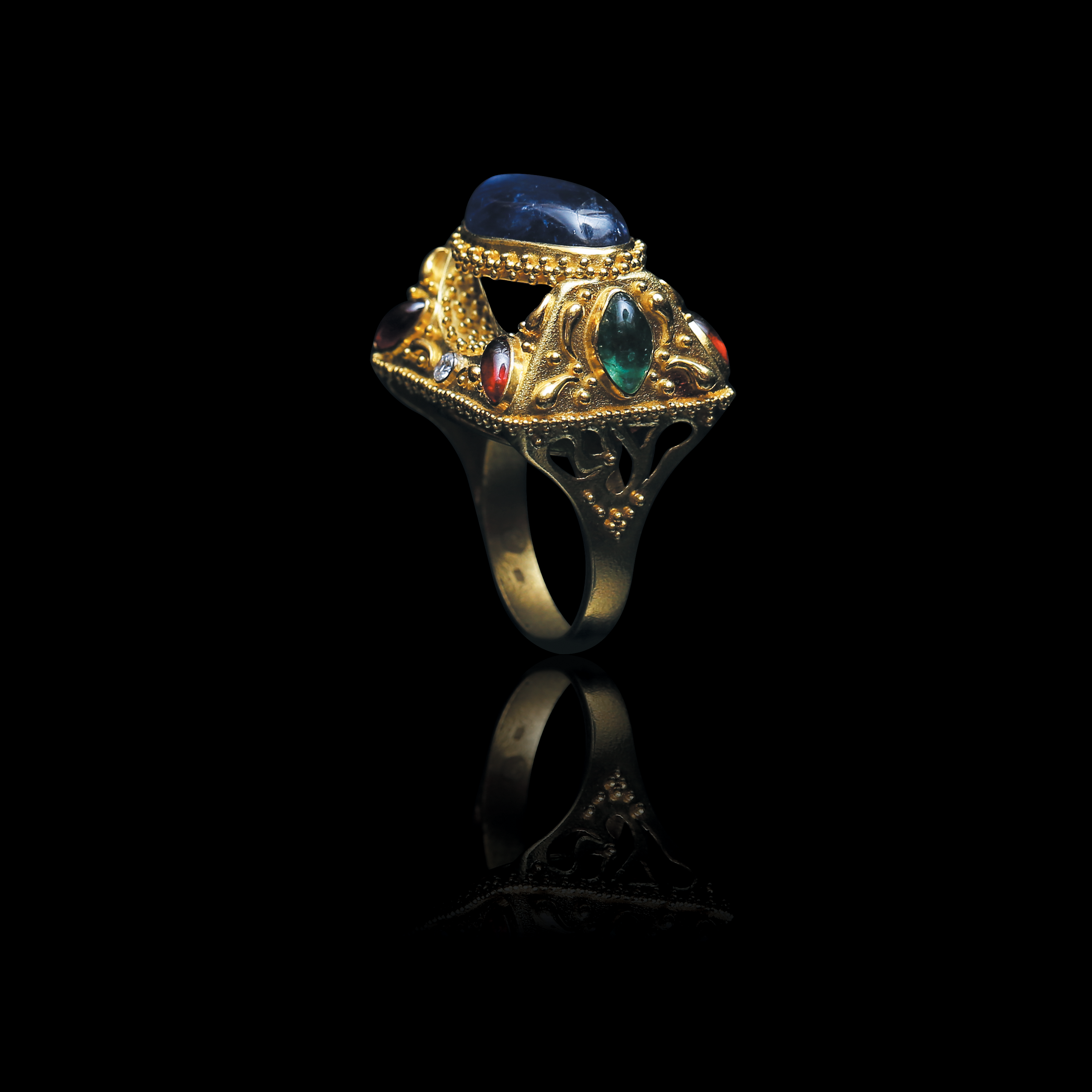 Beautiful high jewelry ring with gold sculpted gold work star sapphire emeralds and rubies from Marilisi Jewelry House