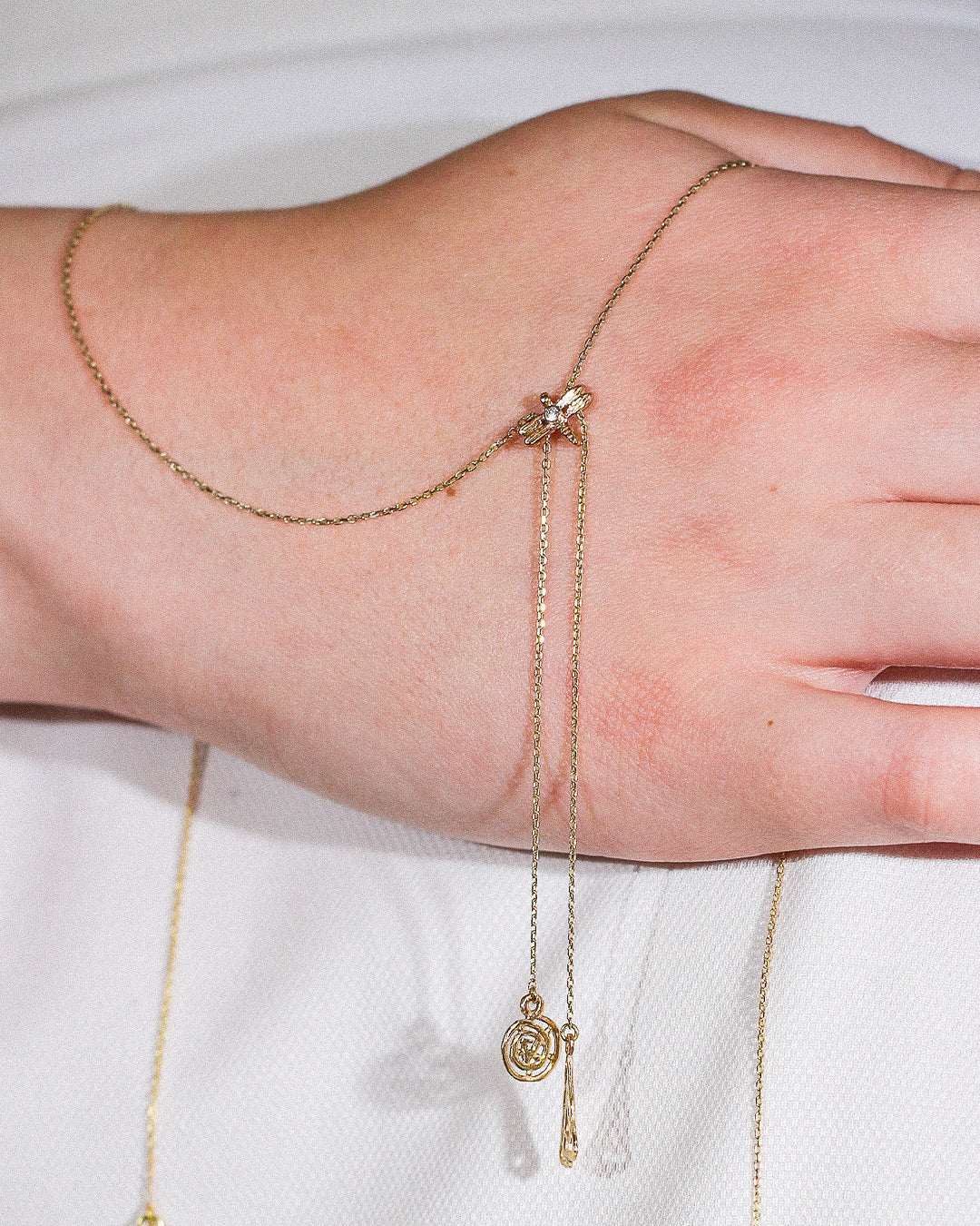 Marilisi artisan fine jewelry Yellow Gold Necklace Dragonfly charm on model