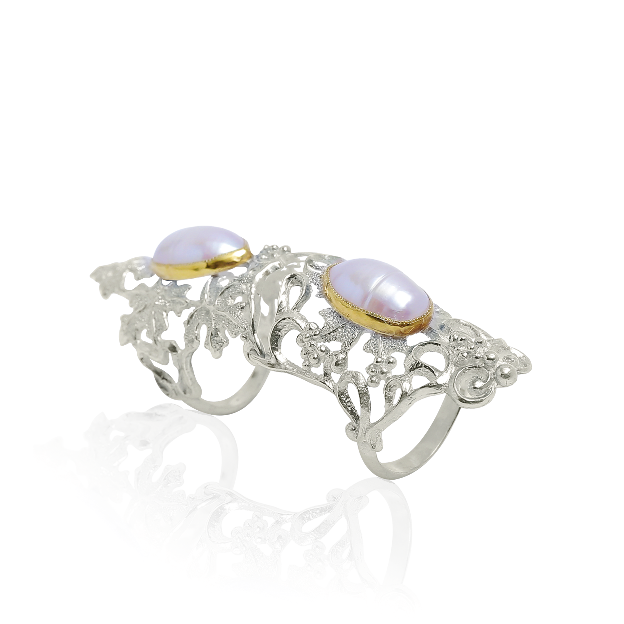 Silver armor ring with gold accents and two pearls on a white background